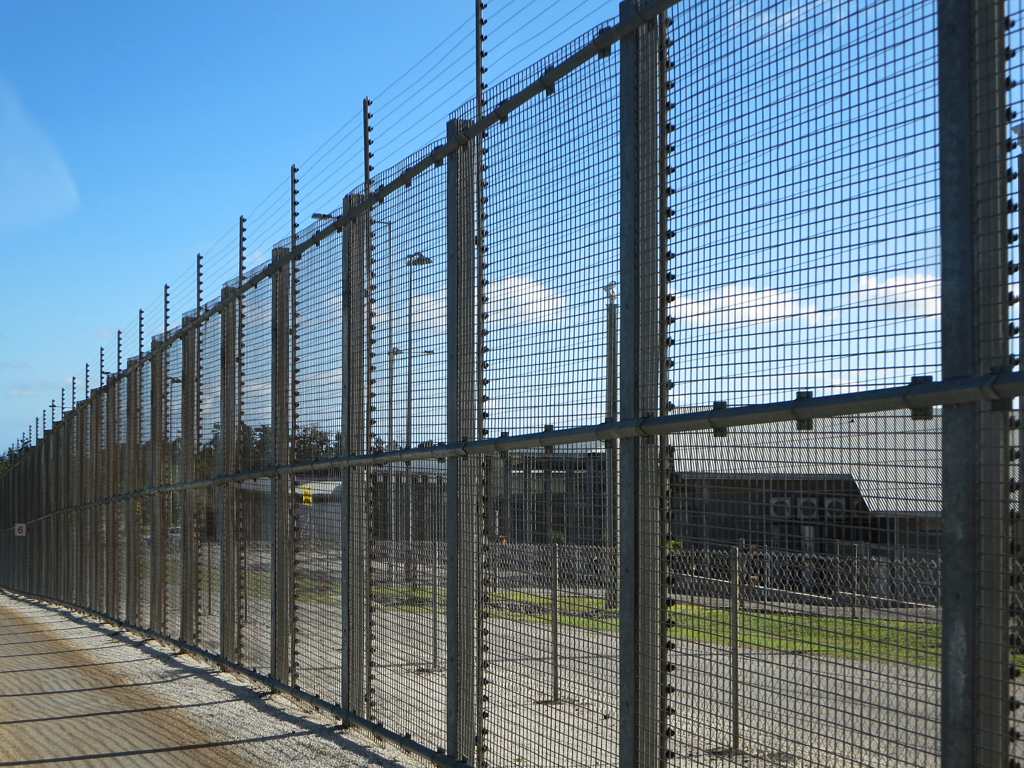 Secure fencing surrounds the Detention Center on Christmas Island, Australia. In 2015 some 150 male asylum seekers to Australia were being held here.